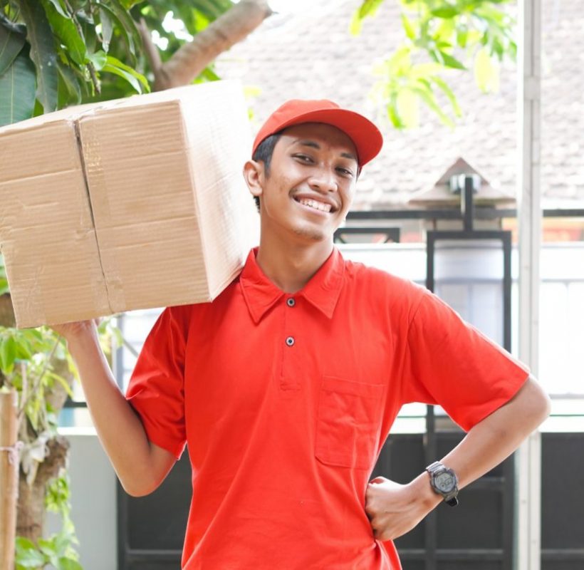 delivery man delivers the box in front of the customer's house